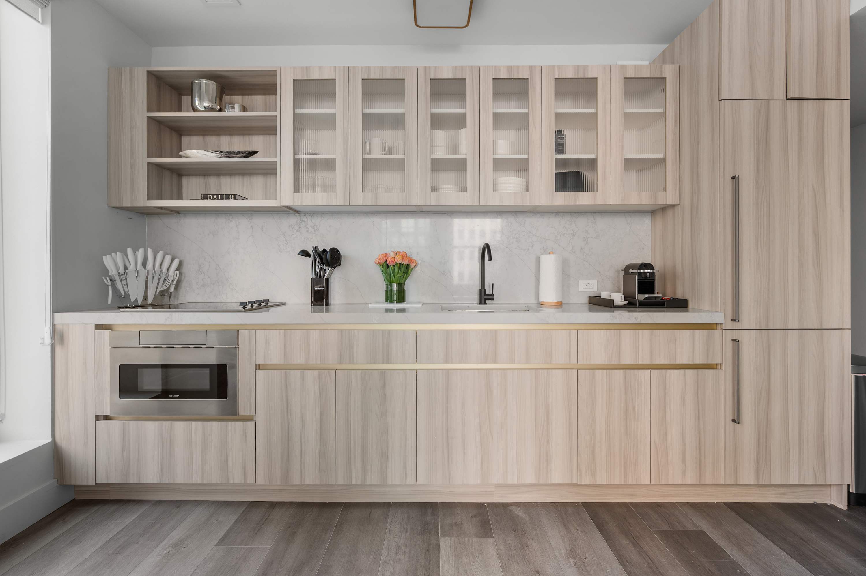 Suite kitchen with wooden cabinets and a marble countertop at 17 John