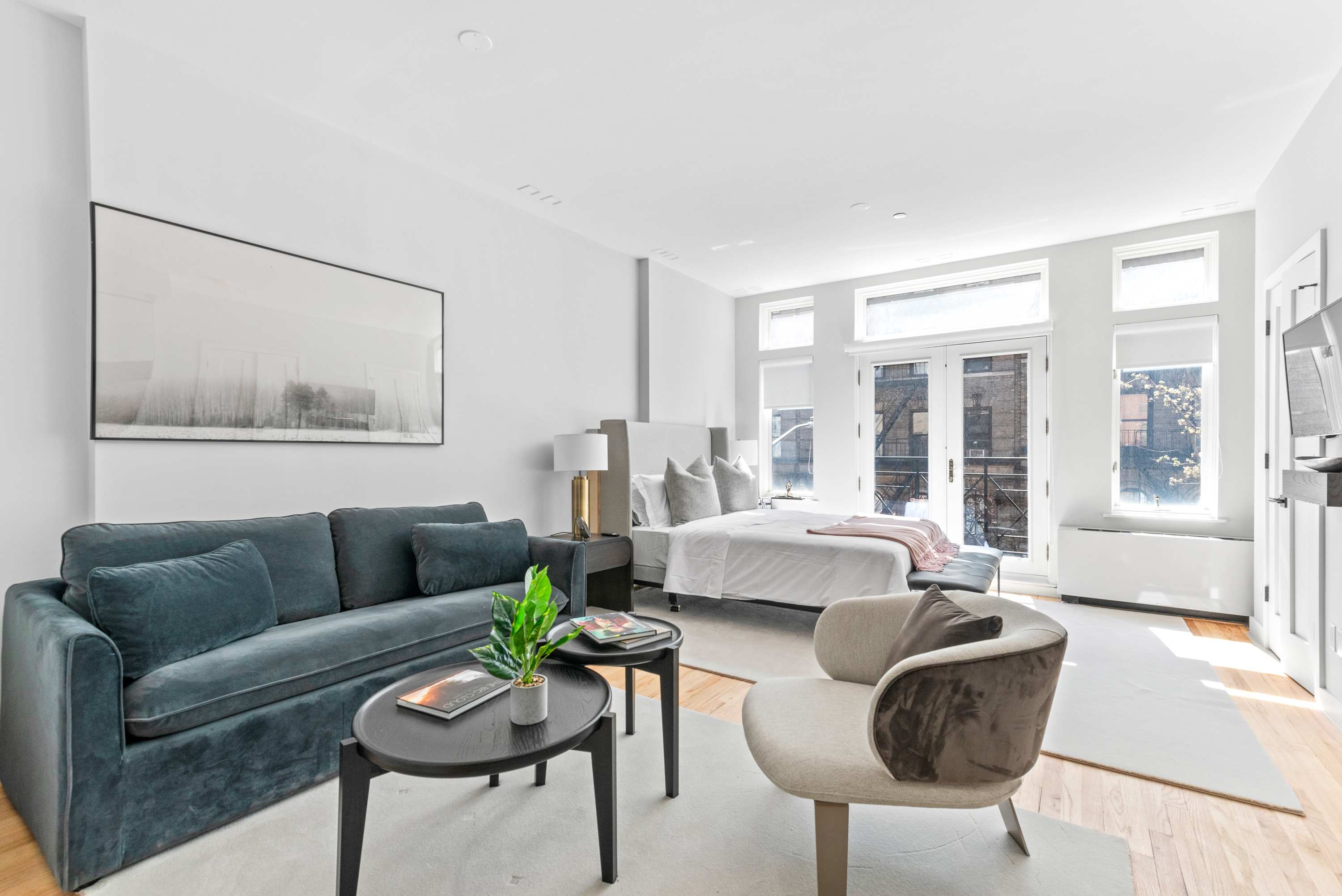 Modern living room with white walls and wooden floors in an apartment at The Sixty Two, East 62nd Street, New York