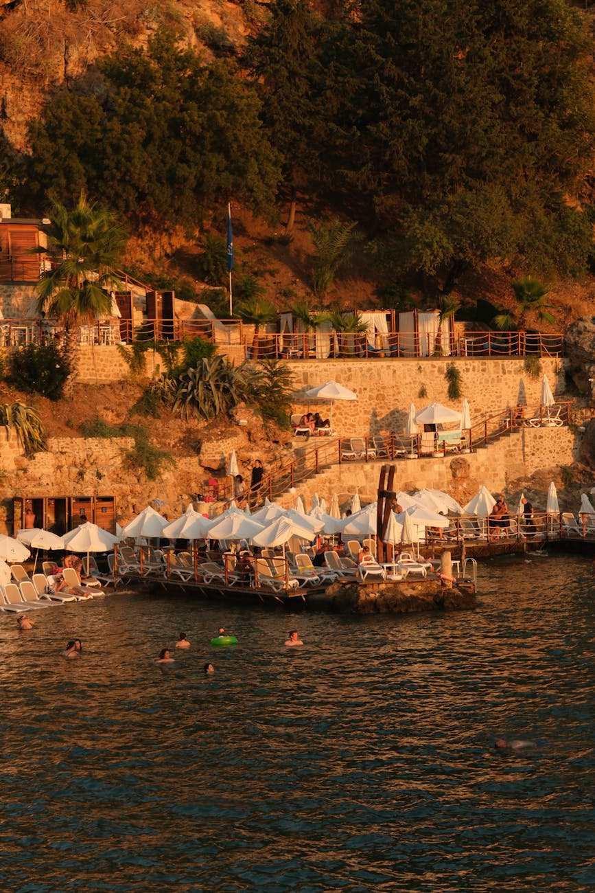 Beach club umbrellas and swimmers on the shore at Blue Apple Beach, Isla Tierra Bomba