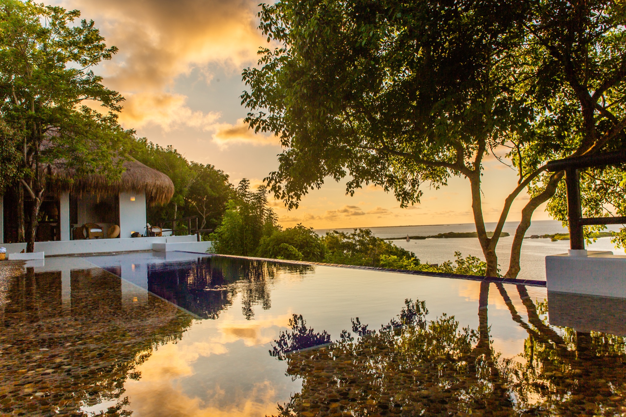 A pool at Casas Altas looking west over the water towards the sunset.
