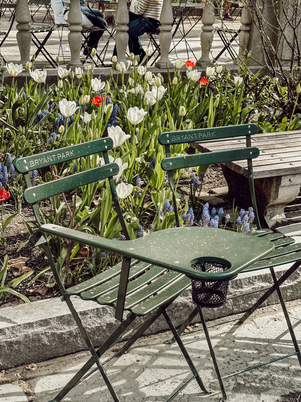 Green movable chairs and tulips in Bryant Park, New York City