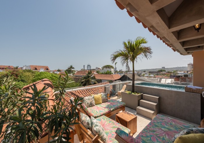 Our rooftop terrace with the pool and lounge seating, above Cartagena's Old Town