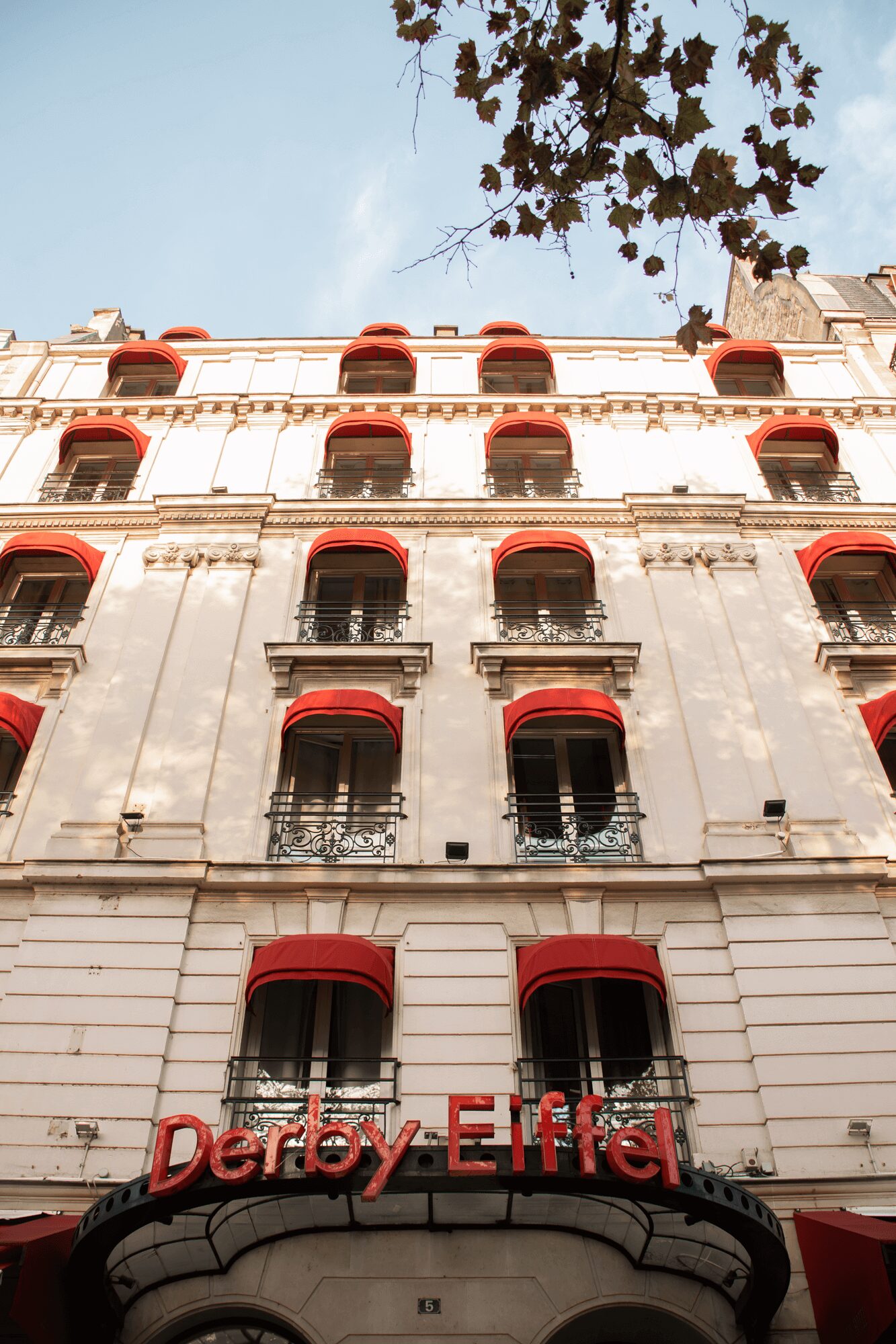 White façade and red blinds of our hotel, avenue Duquesne, Paris 7th