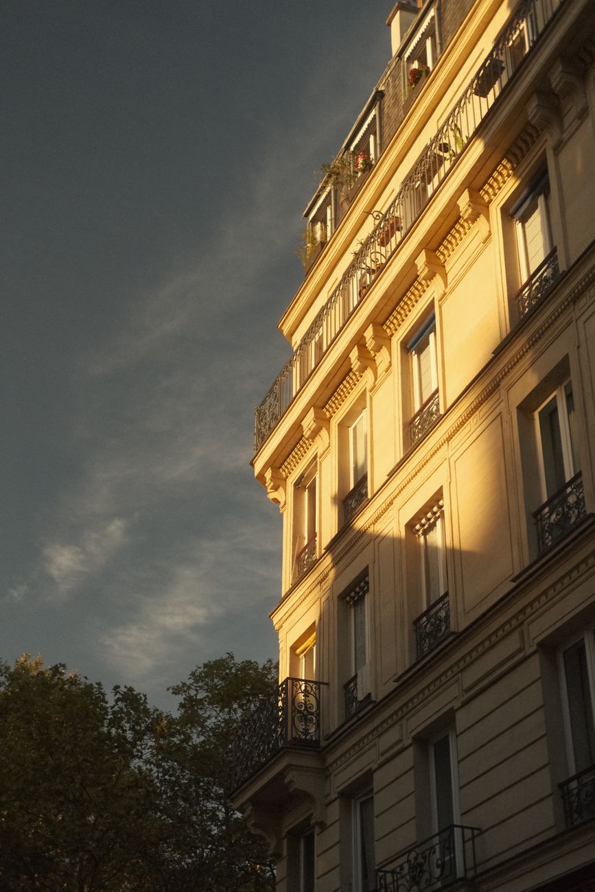 Parisian Haussmannian façade lit by late‑day light