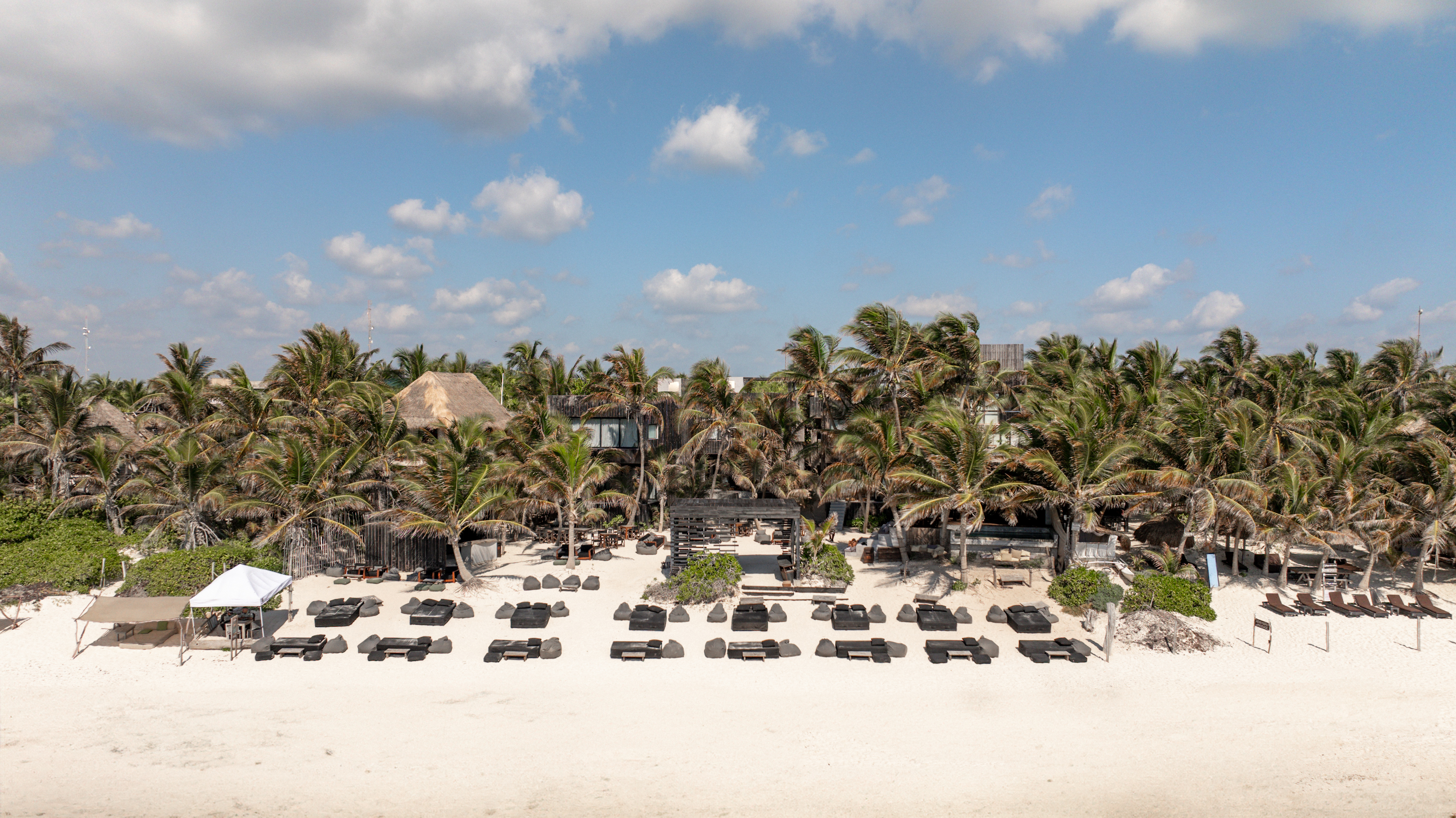 The UMi beach club and palms seen from the sea on Tulum Beach Road