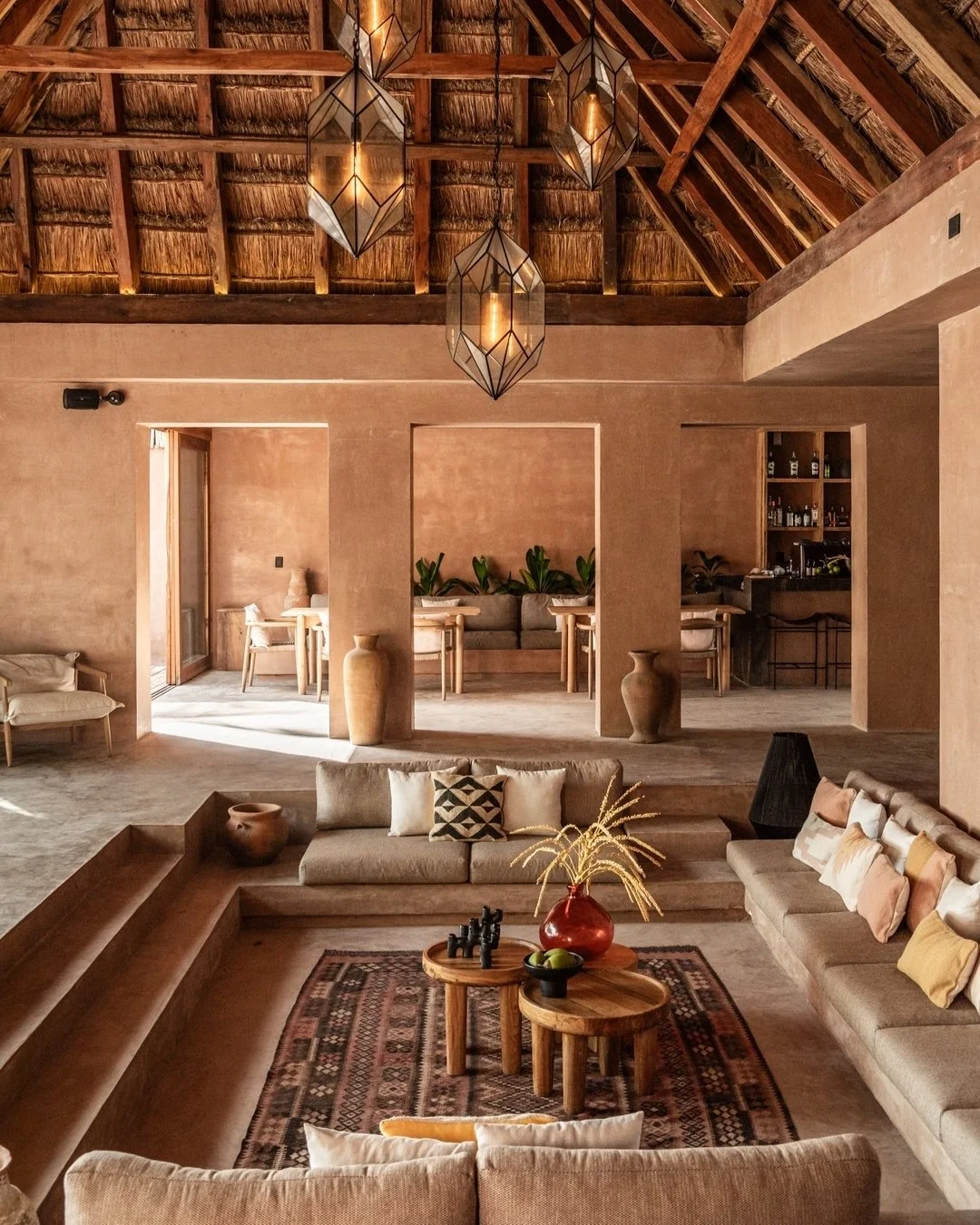 The central roofed patio at XELA with a sunken living room, bar and dining area