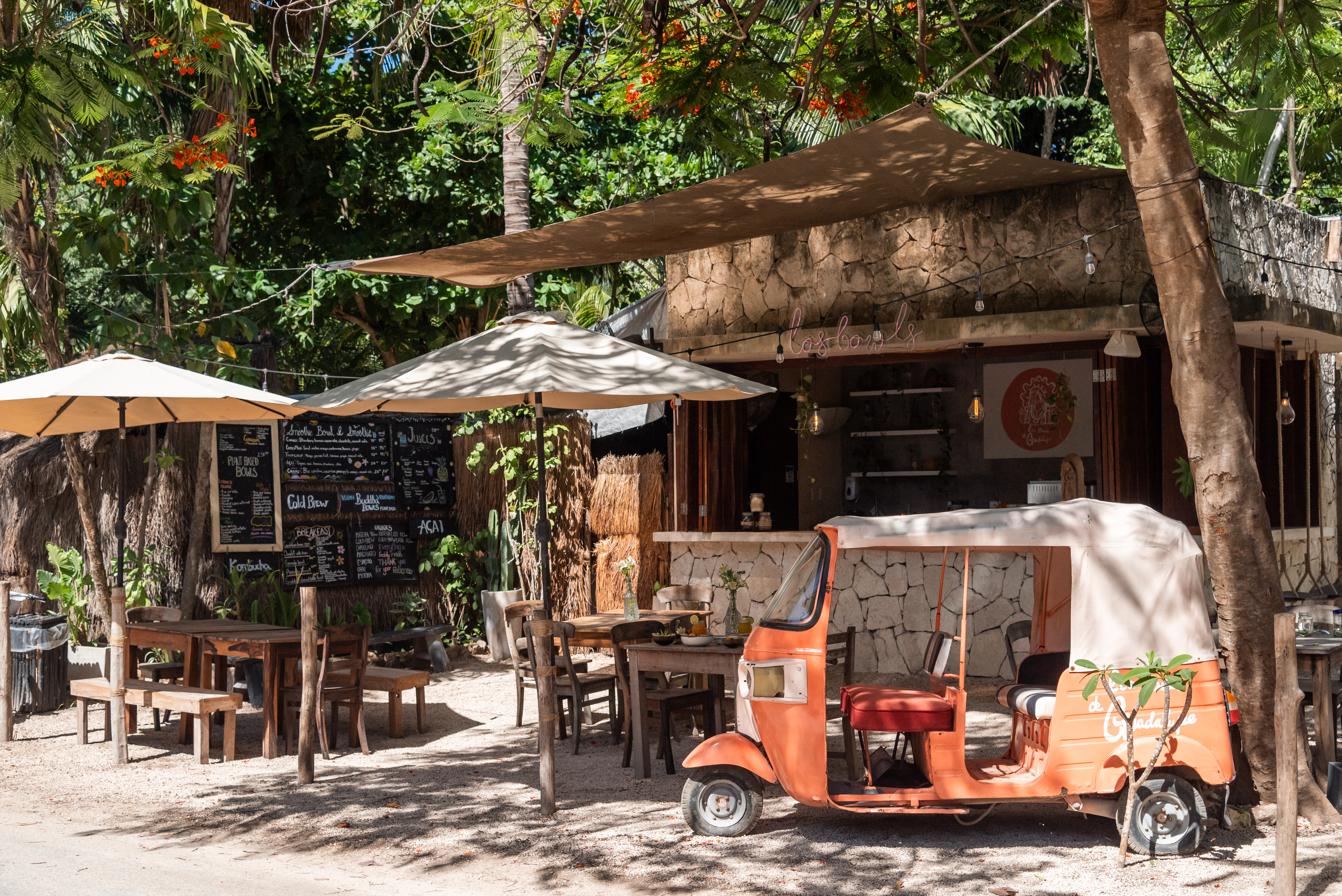 Los Bowls de Guadalupe roadside shack with shaded tables and chalkboard menus