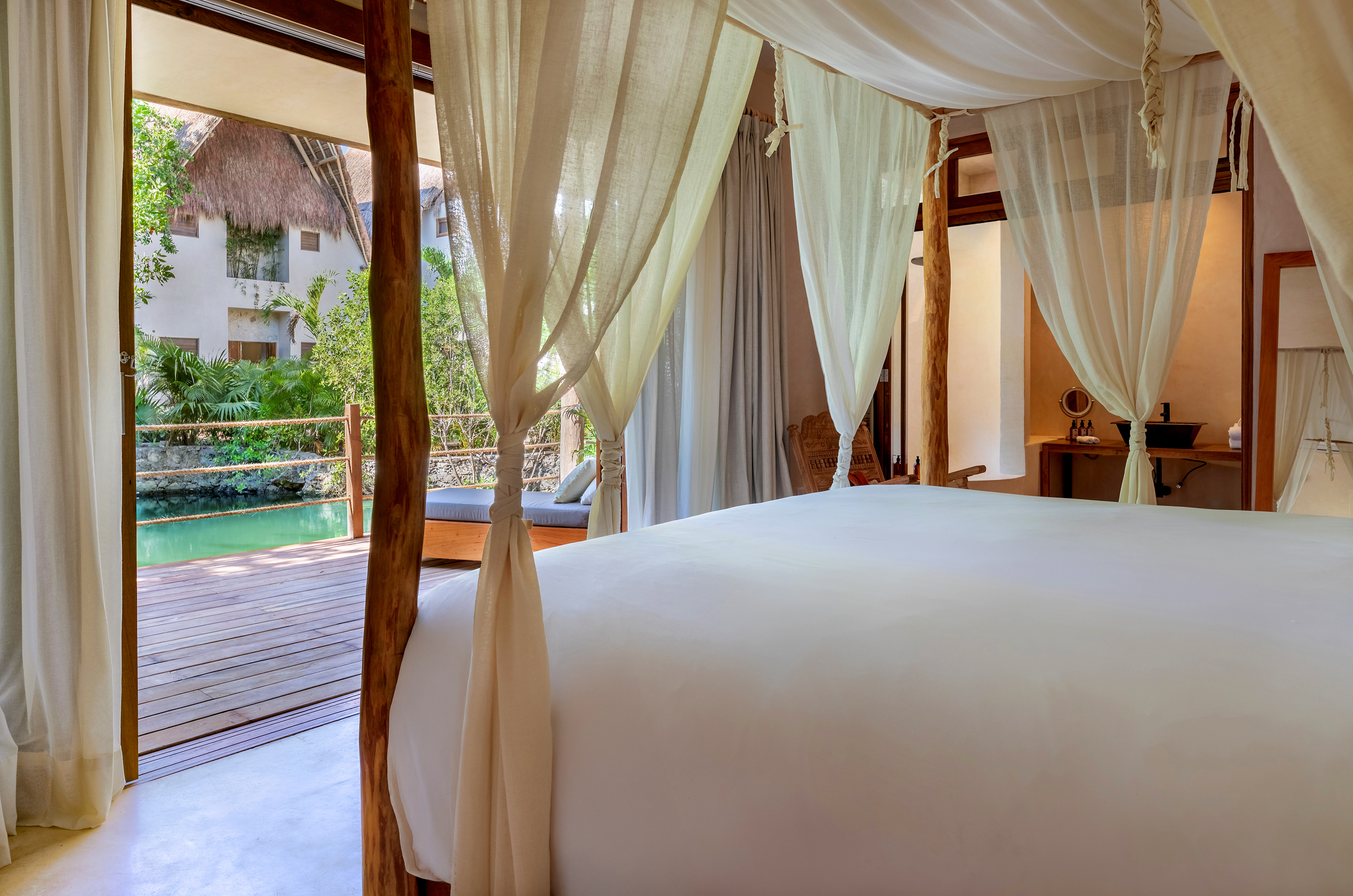 King bed in the Jaguar Suite looking out over the cenote at La Valise Tulum