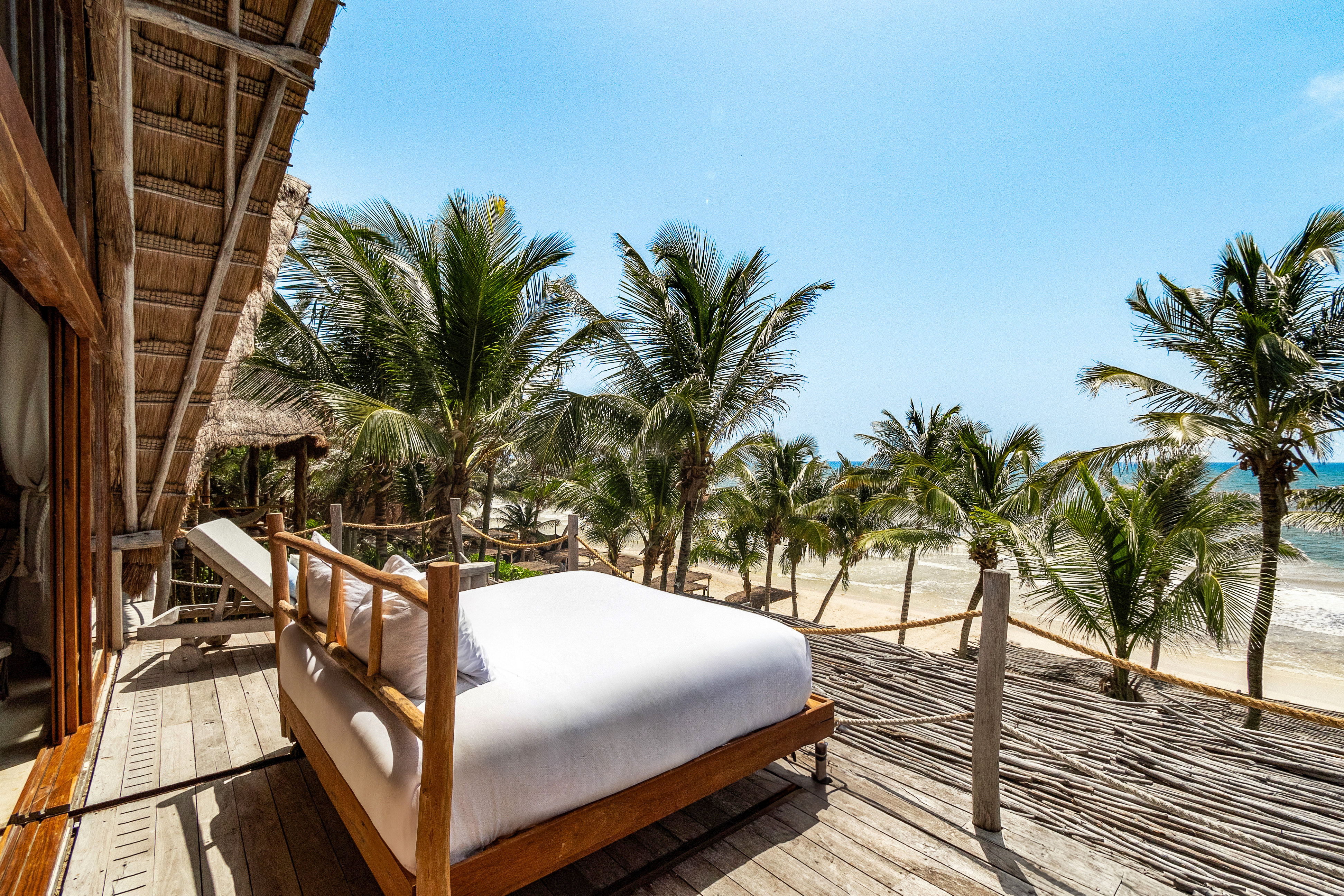 King bed rolled out onto the terrace above the beach at the Robinson Master Suite